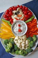 Bring a healthful dish to your next holiday party. How about a veggie tray shaped like a snowman with spinach dip? (photo by Pixabay)