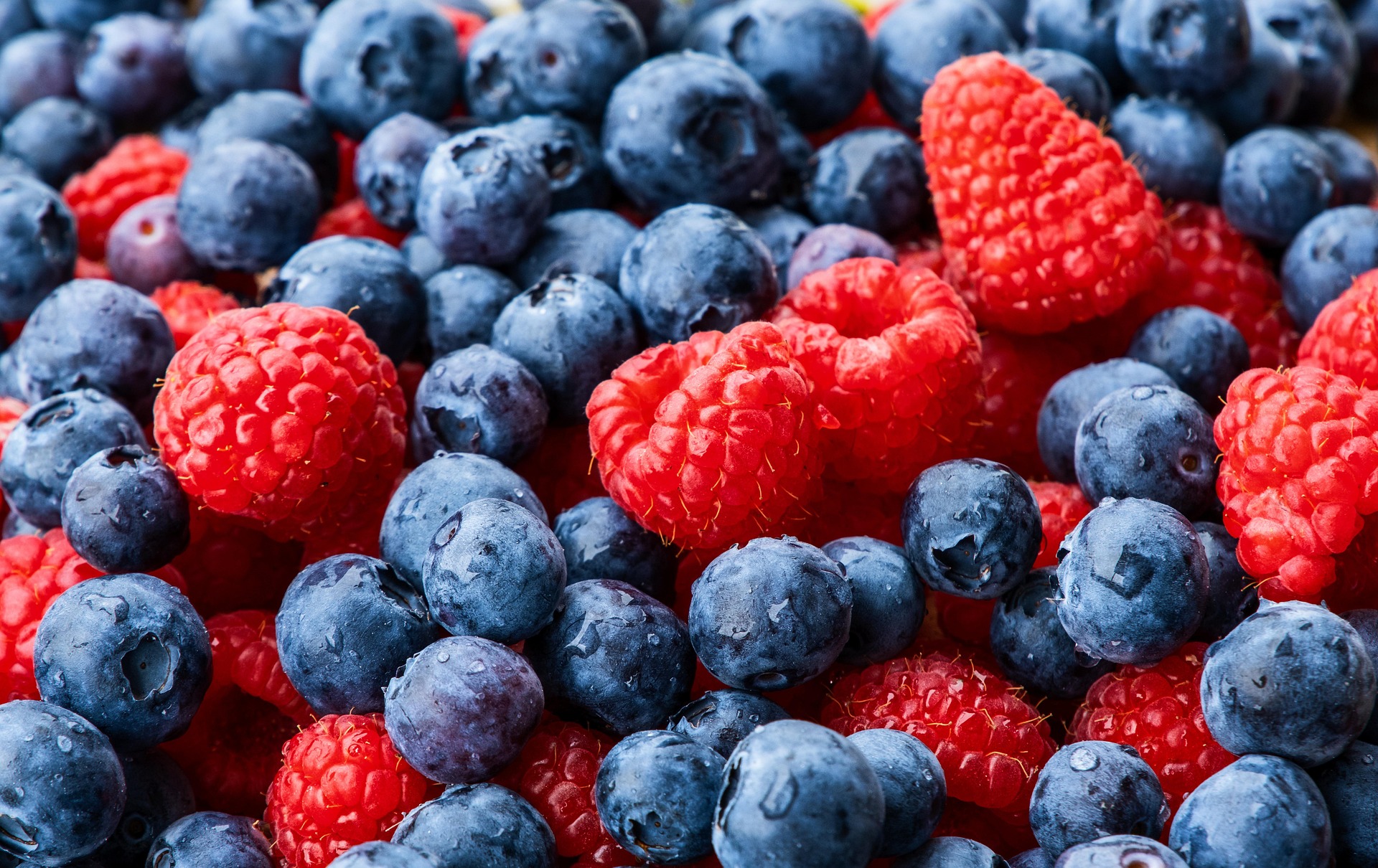 Raspberries and blueberries get their vibrant color from anthocyanin pigments, which may provide heart health benefits and reduce cancer risk. (Pixabay photo)