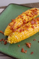 This recipe pairs corn on the cob with bacon and hot sauce. (NDSU photo)
