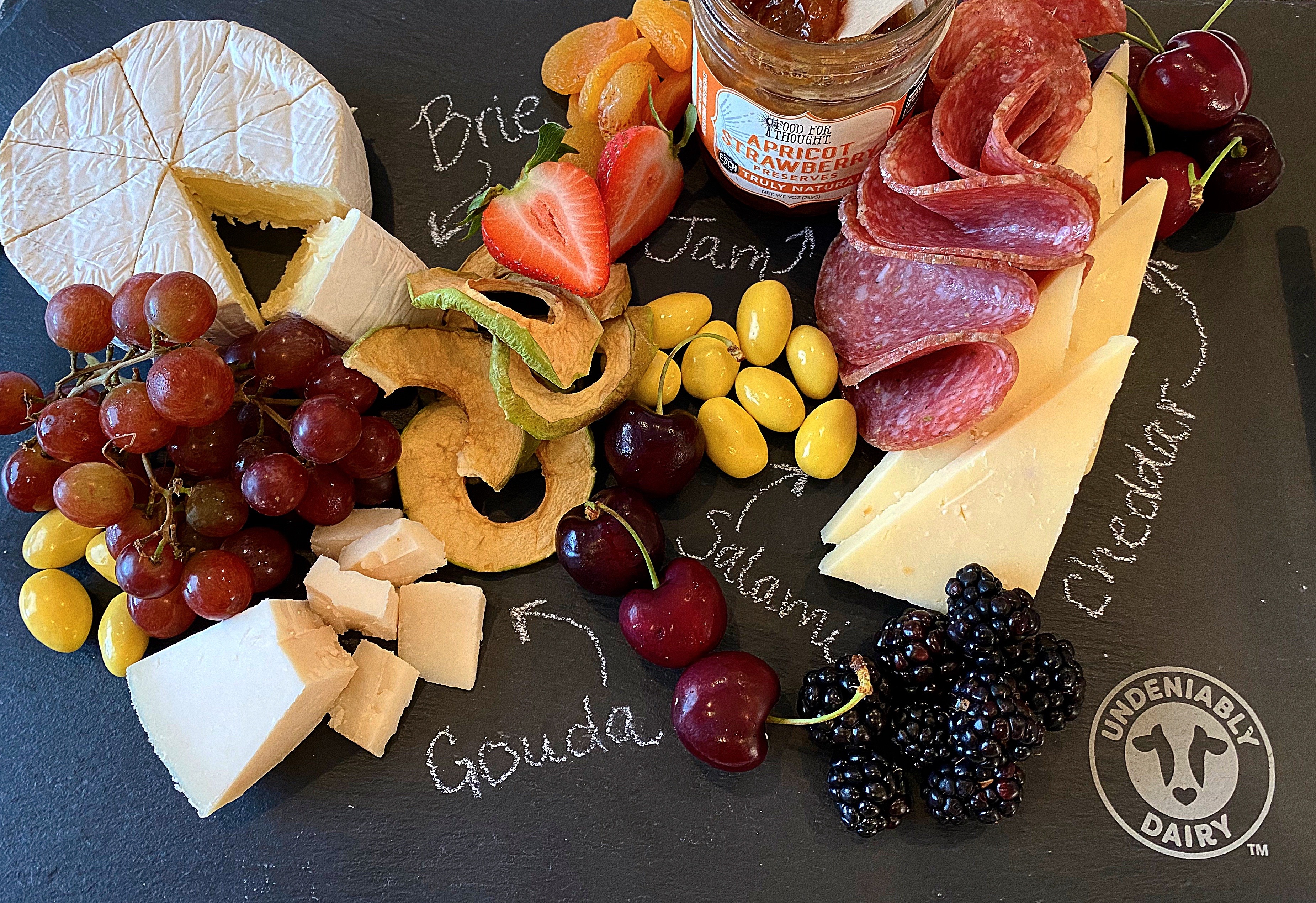 A cheese board has a range of cheese, meat, vegetables, fruits and grain items on the side. (Photo courtesy of Midwest Dairy)