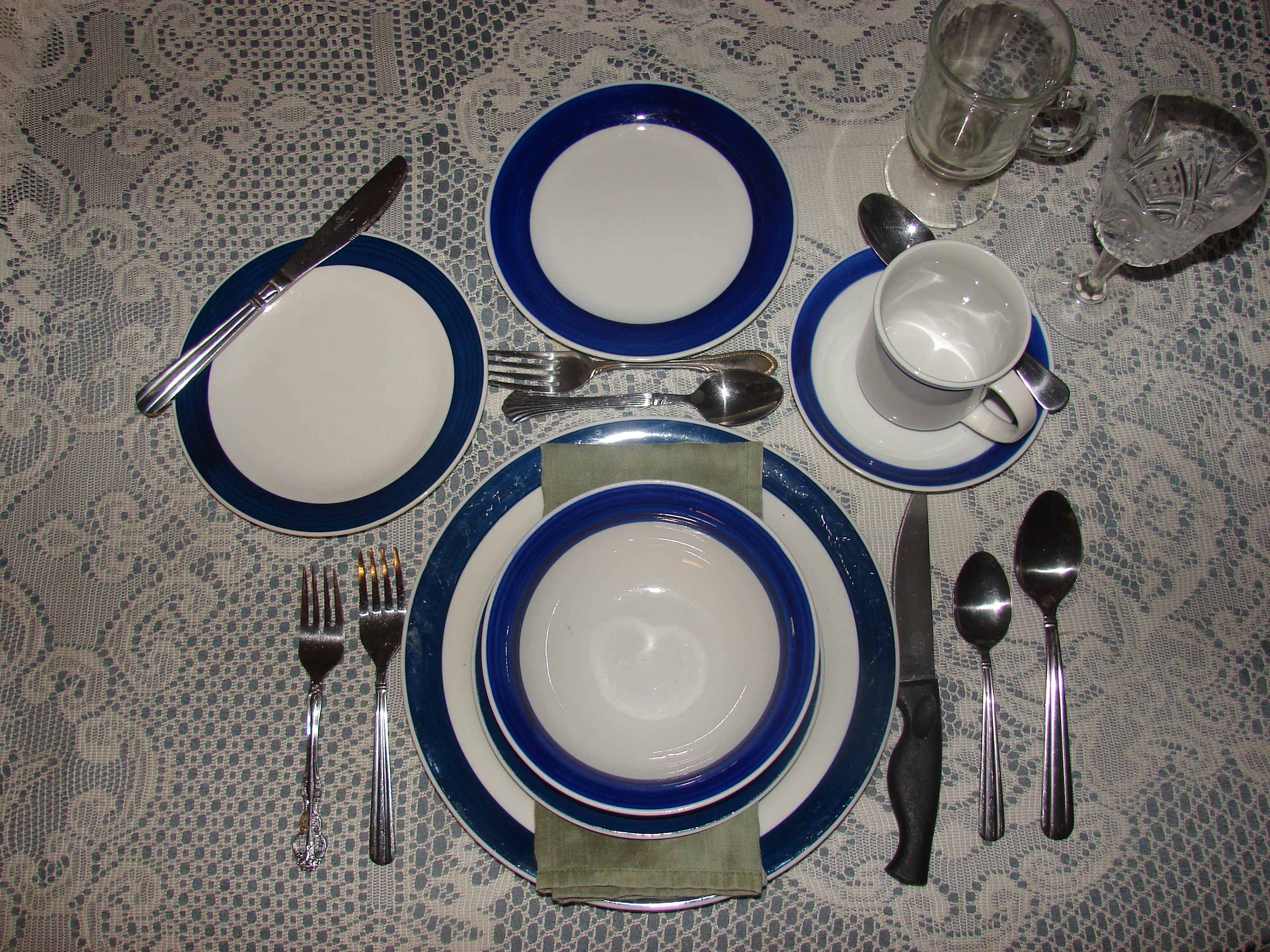 A formal table setting may include a lineup of utensils and glasses. (Photo courtesy of Jessalrene, Morguefile)