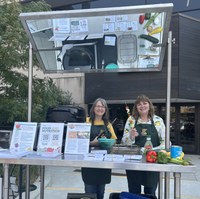 Julie Garden-Robinson, NDSU Extension food and nutrition specialist, and Beth Dahl, grant coordinator, share a cooking demo at the Red River Market. (NDSU photo)