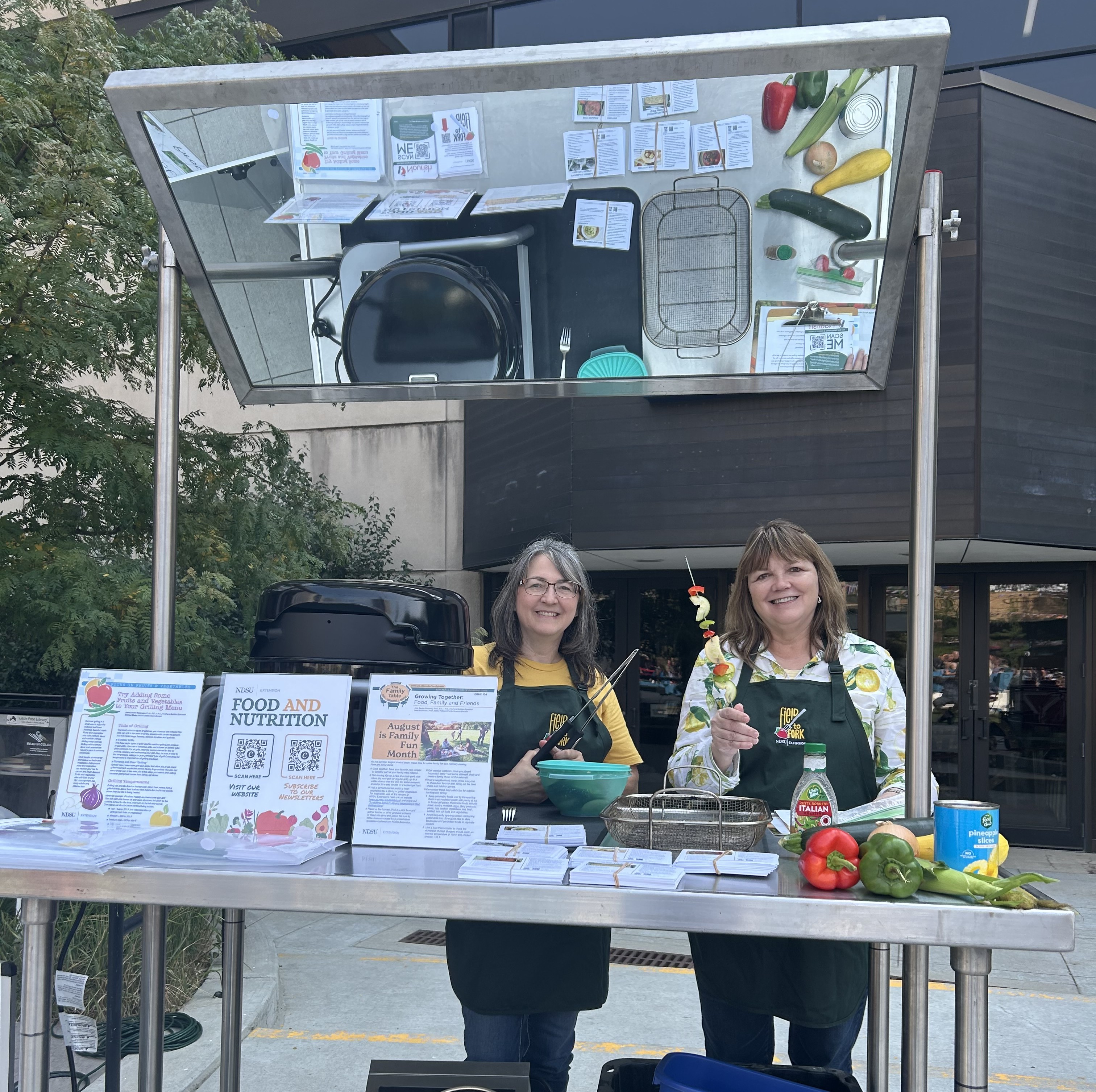 Julie Garden-Robinson, NDSU Extension food and nutrition specialist, and Beth Dahl, grant coordinator, share a cooking demo at the Red River Market. (NDSU photo)