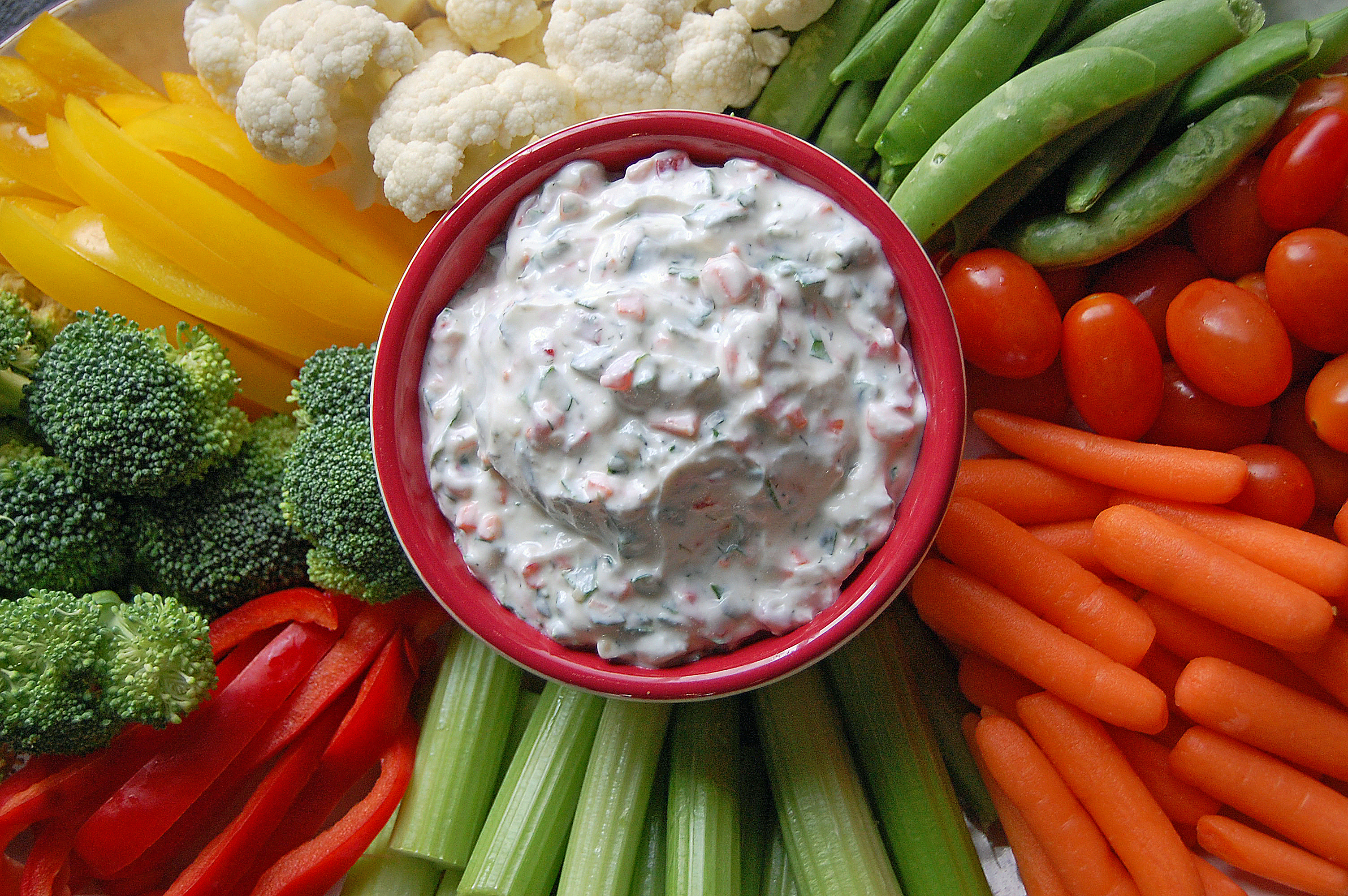 This spinach dip makes use of some of summer’s bounty, the super-nutritious green veggies spinach and kale, along with carrots and bell peppers. (NDSU photo)