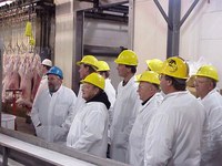 Producers tour a lamb meat packing plant.