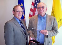North Dakota State University President Joseph Chapman, right, receives a leadership award named for him from D.C. Coston, NDSU vice president for Agriculture and University Extension.