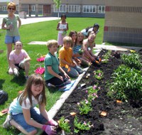 Members of the Rainbow Kids 4-H Club in Cass County plant flowers. This is one activity that helped the club earn recognition as a Healthy North Dakota 4-H Club.