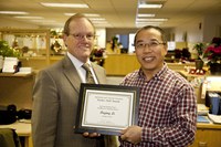 D.C. Coston, NDSU vice president for Agriculture and University Extension (left), presents the Earl and Dorothy Foster Excellence in Teaching Award to Deying Li, an associate professor in the Plant Sciences Department.
