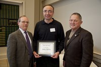 NDSU Vice President for Agriculture and University Extension D.C. Coston, left, presents the Larson/Yaggie Excellence in Research Award to Dragan Miljkovic (center), a professor in the Agribusiness and Applied Economics Department. Bob Yaggie, right, is a sponsor of the award.
