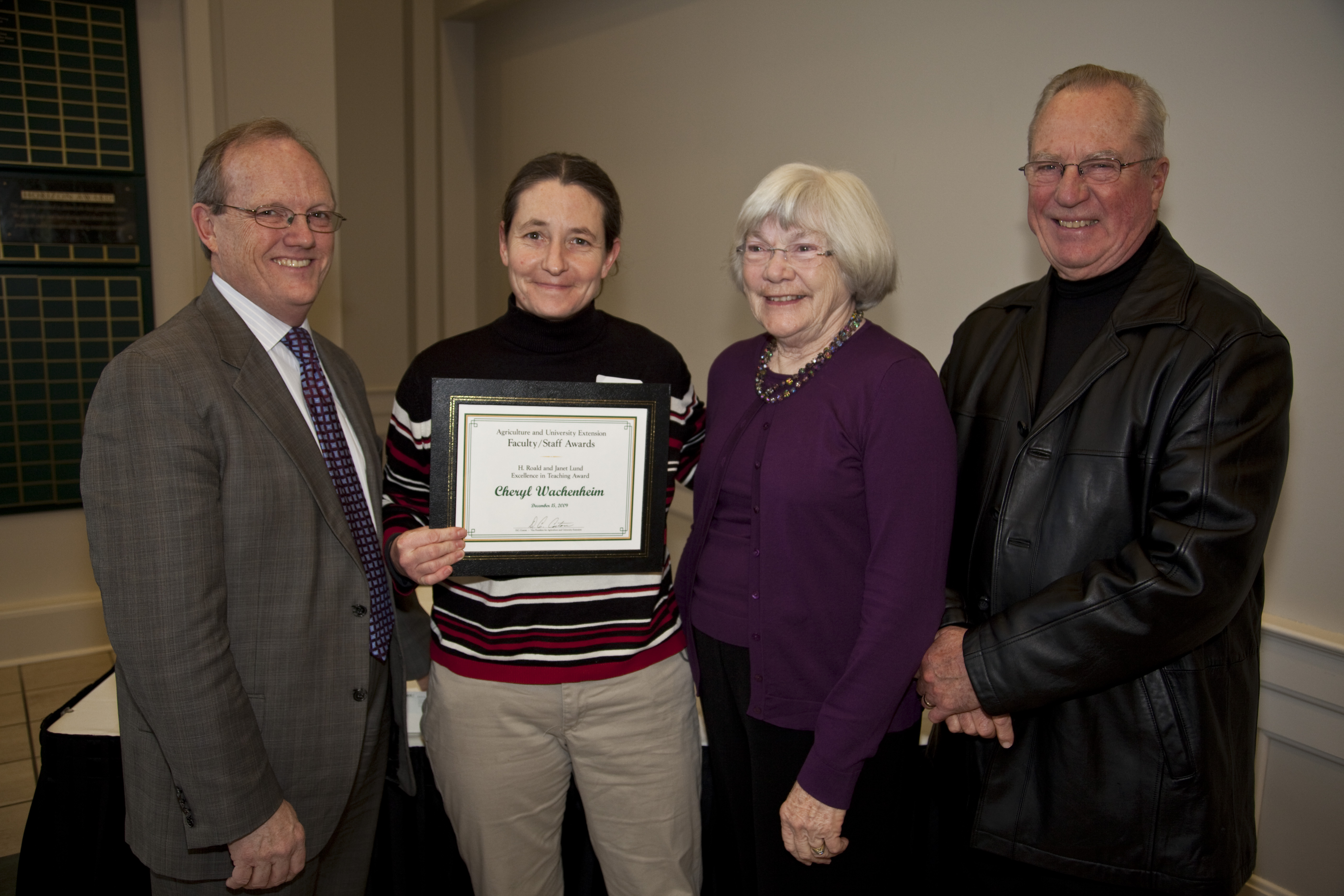 NDSU Vice President for Agriculture and University Extension (left), presents the H. Roald and Janet Lund Excellence in Teaching Award to Cheryl Wachenheim (second from left), an associate professor in the Agribusiness and Applied Economics Department. Janet and H. Roald Lund, right, are the award's sponsors.