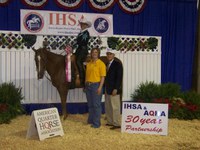 Janelle Lanoue displays the ribbon she won in the Intercollegiate Horse Show Association's national competition in Murfreesboro, Tenn. Also pictured are Tara Swanson, her coach, and Bob Cacchione, IHSA founder.