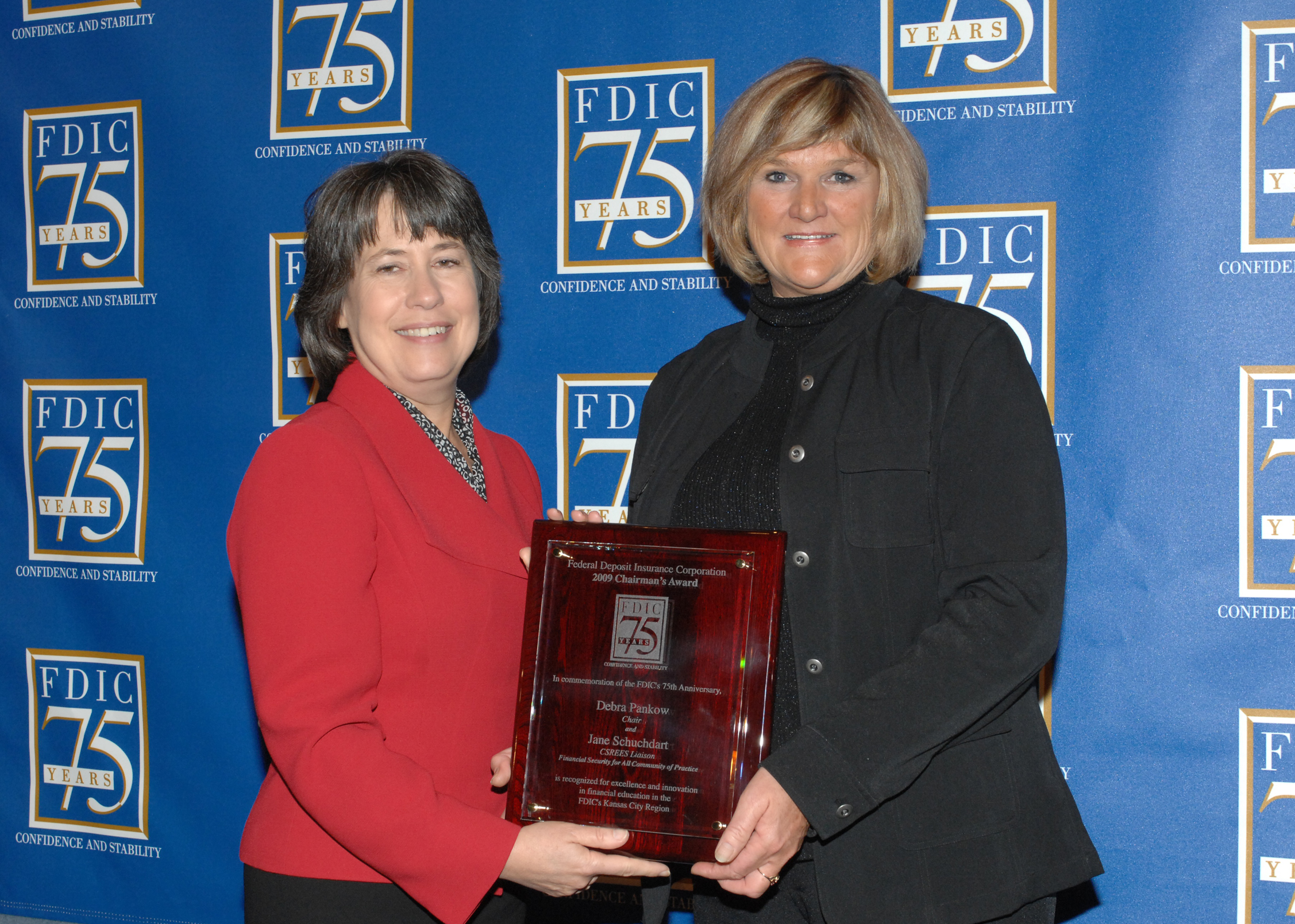 NDSU Extension Service family economics specialist Debra Pankow, right, receives the Chairman's Award for Innovation in Financial Education from Sheila Bair, FDIC chairwoman.