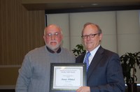 Dennis Whitted, left, research specialist in the NDSU School of Natural Resource Sciences (Range Science), receives the Charles and Linda Moses Staff Award from D.C. Coston, vice president for Agriculture and University Extension.