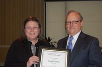 Sandy Osborne, administrative coordinator in the Agribusiness and Applied Economics Department, receives the Rick and Jody Burgum Staff Award from D.C. Coston, vice president for Agriculture and University Extension.
