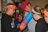 Mountrail County Extension agent Jim Hennessy, center, works with youth attending Survivor Camp at the Western 4-H Camp near Washburn, N.D.