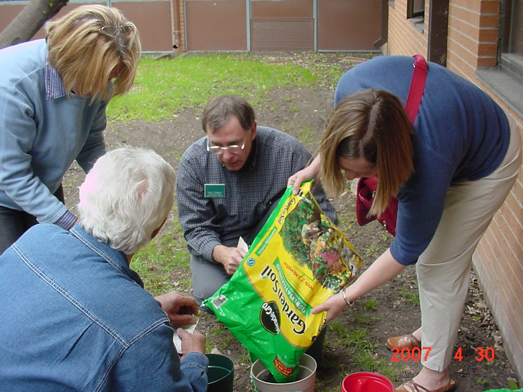 Steve Sagaser (center), a Grand Forks County Extension agent, leads a class for adults on container gardening.