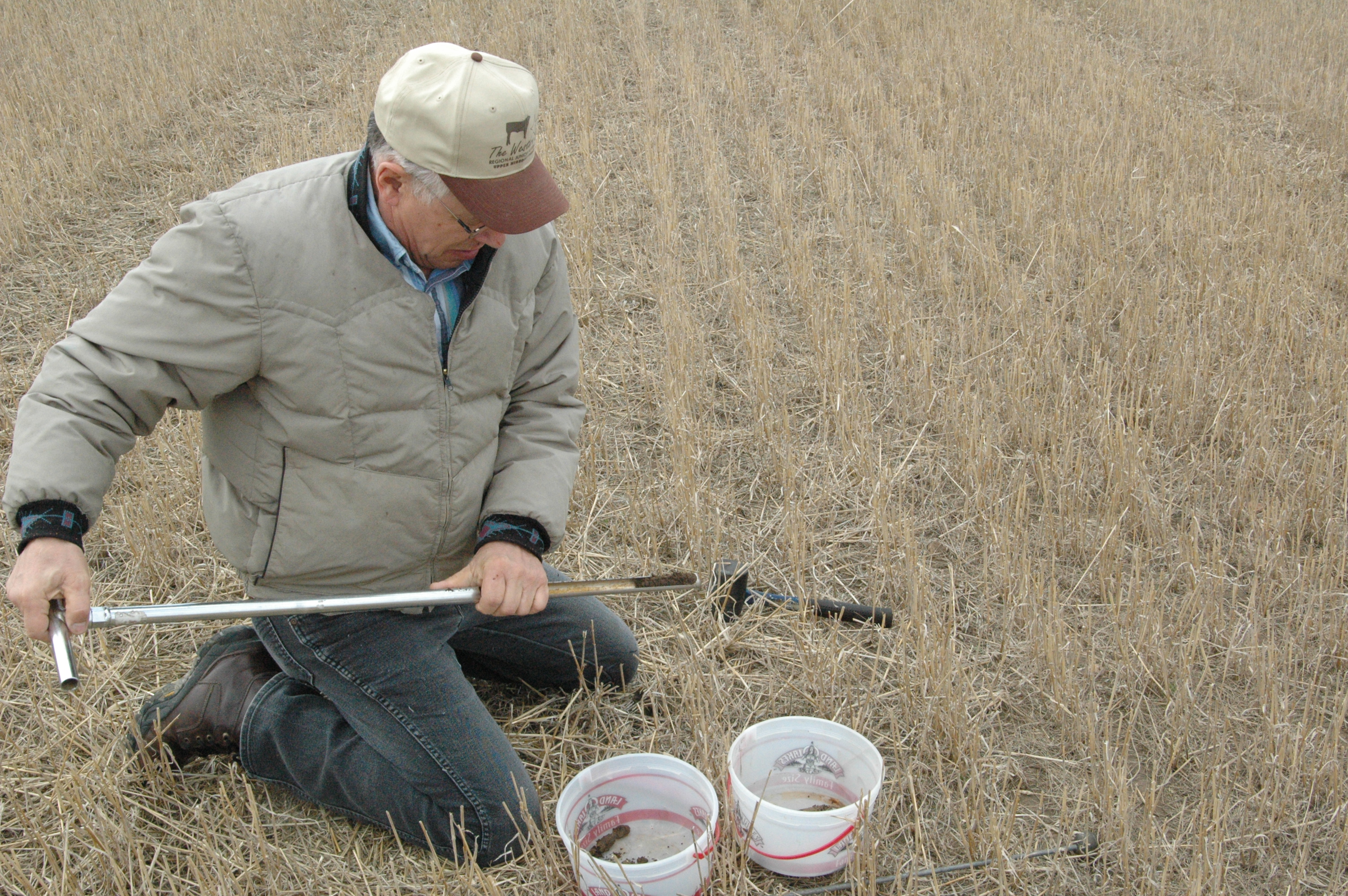 Williams County Extension agent Warren Froelich takes a soil sample.