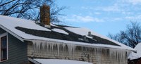 An ice dam forms when snow melts and the water runs down the roof, then freezes when it reaches cooler parts of the roof near the eaves.