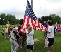 Youth help raise the U.S. flag during Military Youth Camp at the Western 4-H Camp near Washburn in summer 2010.