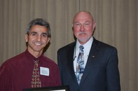 Adnan Akyuz (left) receives the Earl and Dorothy Foster Excellence in Teaching Award from Ken Grafton, vice president for Agriculture and University Extension.