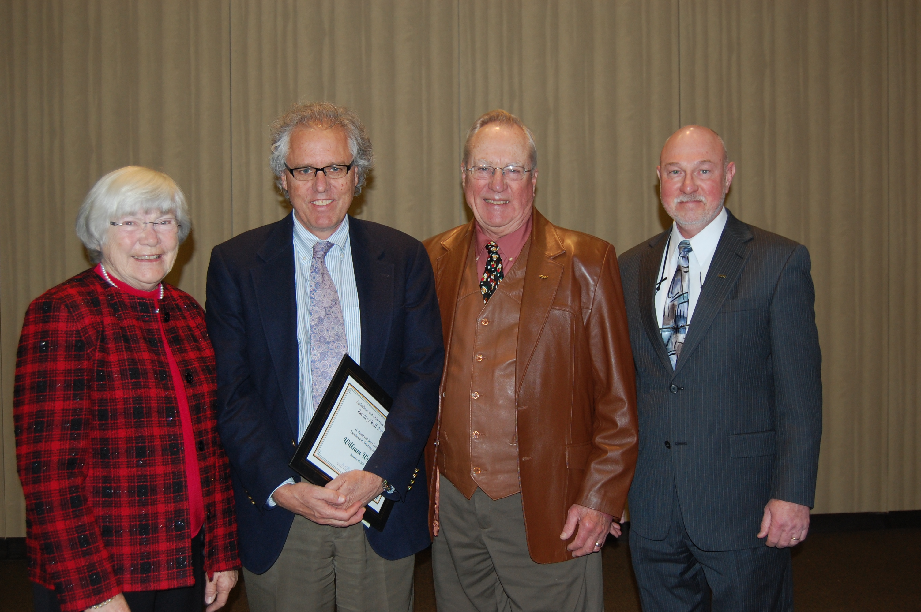 Bill Wilson (second from left) receives the H. Roald and Janet Lund Excellence in Teaching Award from Ken Grafton (far right), vice president for Agriculture and University Extension. Janet Lund (left) and H. Roald Lund (second from right) are the sponsors of the award.