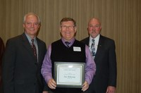 Ken Hellevang (center) receives the AGSCO Excellence in Extension Award from Duane Hauck (left), Extension Service director, and Ken Grafton, vice president for Agriculture and University Extension.
