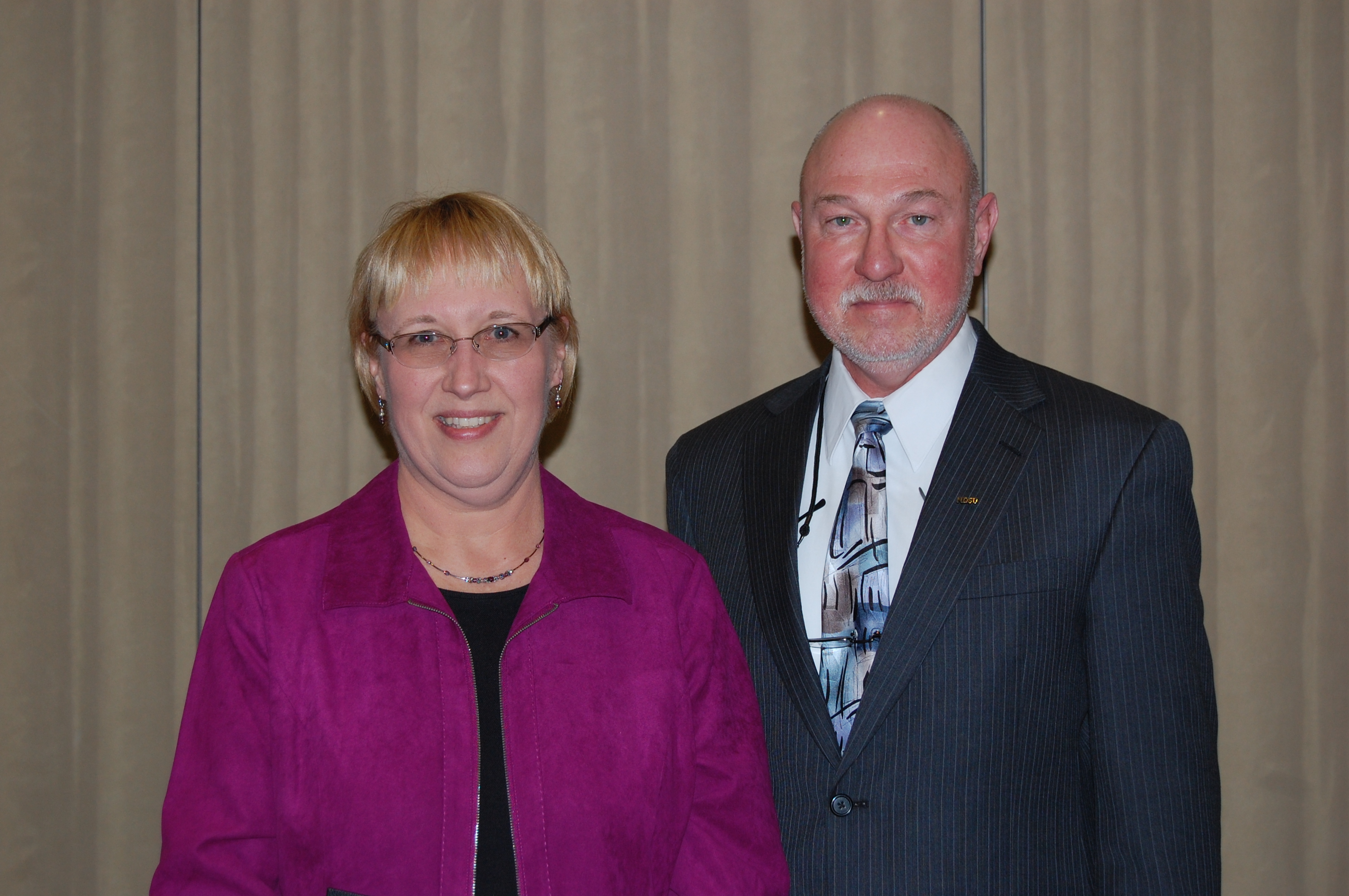 Mary Finseth receives the Charles and Linda Moses Staff Award from Ken Grafton, vice president for Agriculture and University Extension.