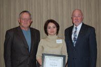 Senay Simsek receives the Larson/Yaggie Excellence in Research Award from Ken Grafton, vice president for Agriculture and University Extension (right). Bob Yaggie (left) is one of the award's sponsors.