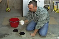 Carl Pedersen, NDSU Extension Service energy educator, demonstrates how to install a drain plug.