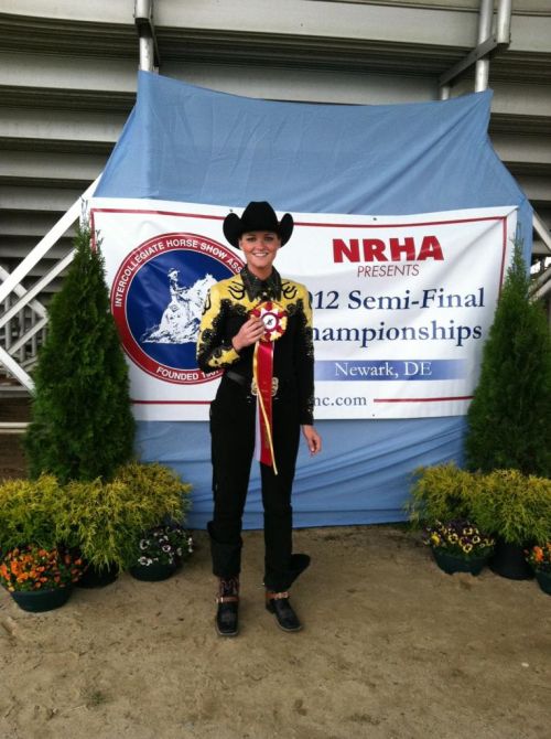 NDSU rider Hannah Beyer shows off the ribbon she received as reserve champion overall in advanced horsemanship in Intercollegiate Horse Show Association semifinal competition in Harrington, Del.