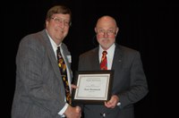 Brad Brummond (left) receives the AGSCO Excellence in Extension Award from Ken Grafton