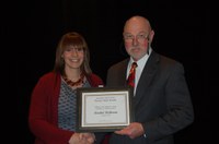 Rachel Richman receives the William J. and Angelyn A. Austin Excellence in Advising Award from Ken Grafton