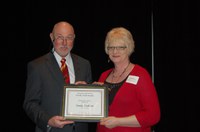 Sandy Erickson receives the Donald and Jo Anderson Staff Award from Ken Grafton