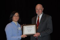Siew Lim receives the Earl and Dorothy Foster Excellence in Teaching Award from Ken Grafton
