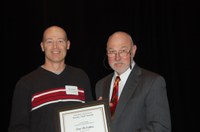 Tom DeSutter (left) receives the Larson/Yaggie Excellence in Research Award from Ken Grafton