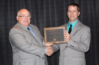 Robert Maddock (right), an associate professor in NDSU's Animal Sciences Department, receives the American Meat Science Association's Distinguished Achievement Award from Casey Frye, the association's treasurer and vice president for research and development at Burke Corp., the award's sponsor.