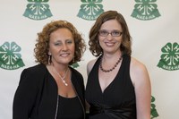 Debbie Nistler, president of the National Association of Extension 4-H Agents, left, congratulates Beth Roth, who received the Distinguished Service Award.