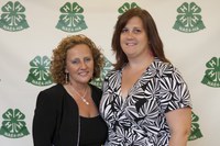 National Association of Extension 4-H Agents President Debbie Nistler, left, congratulates Samantha Roth, recipient of the Achievement in Service Award.
