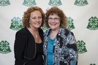 Peggy Anderson, right, receives congratulations from Debbie Nistler, president of the National Association of Extension 4-H Agents, for receiving the Meritorious Service Award.