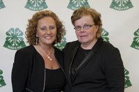 Sue Isbell, right, who was honored with the Distinguished Service Award, receives congratulations from National Association of Extension 4-H Agents President Debbie Nistler.