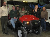 Shelly McPhee of West Fargo sits behind the wheel of the Case IH Scout utility vehicle she won in the North Dakota 4-H Foundation's 2013 fundraising raffle. Others pictured, from left, are Kip Hines, Titan Machinery; Kevin McPhee, the winner's husband; Mariah, their daughter; Cheryl Kuhn, North Dakota 4-H Foundation executive director; and Jay Opoien, Titan Machinery complex manager.