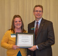 Carrie Knutson, Extension agent, Grand Forks County, receives the Myron and Muriel Johnsrud Excellence in Extension/Outreach Award from Chris Boerboom, director of the NDSU Extension Service.