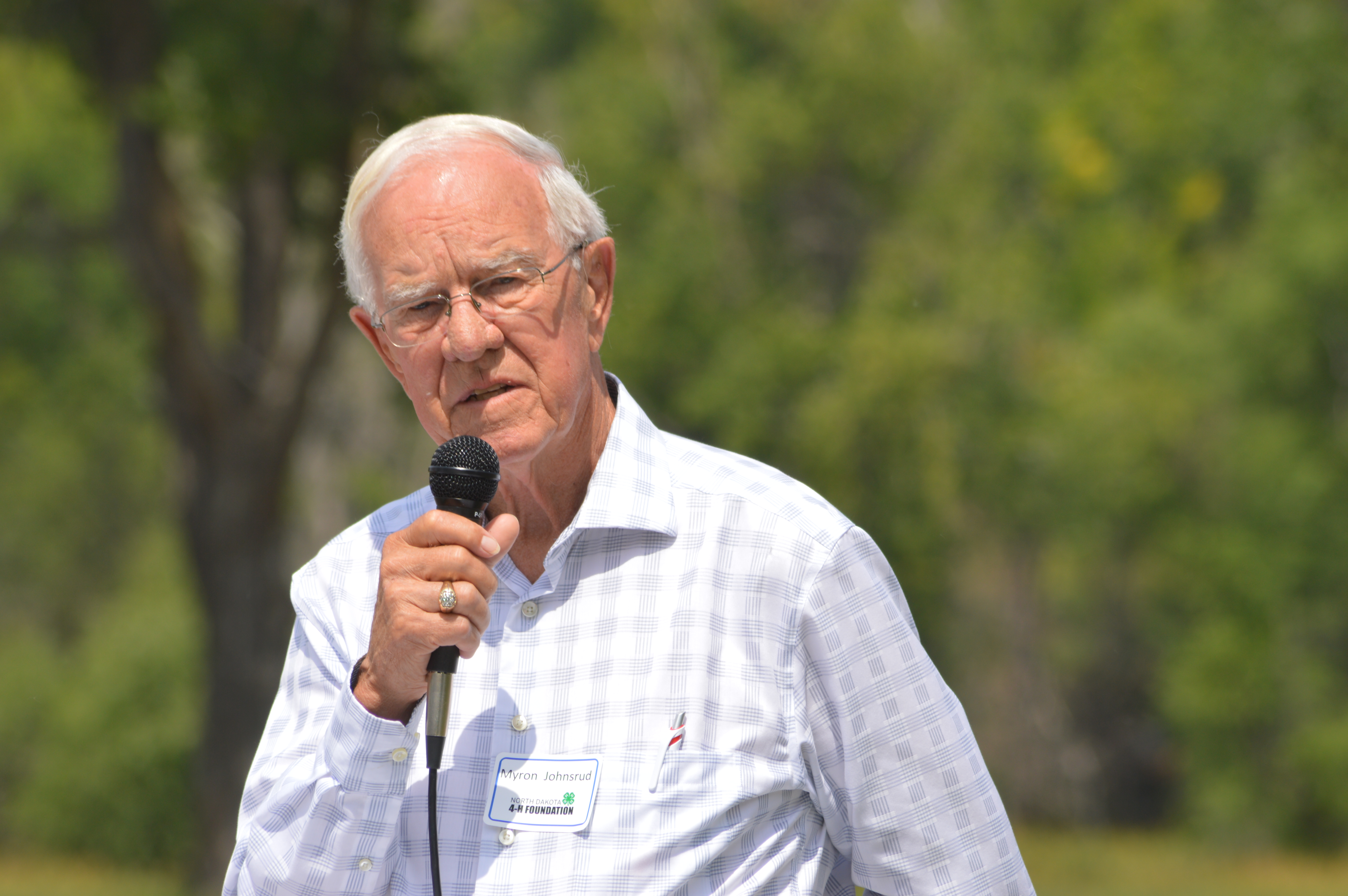 Myron Johnsrud, who served as NDSU Extension Service director from 1974 to 1986, speaks at the groundbreaking for a multipurpose facility at the North Dakota 4-H Camp near Washburn. The facility will be named after Johnsrud, whose family was a major contributor to the campaign to raise money for a $2.3 million renovation project at the camp. (NDSU photo)