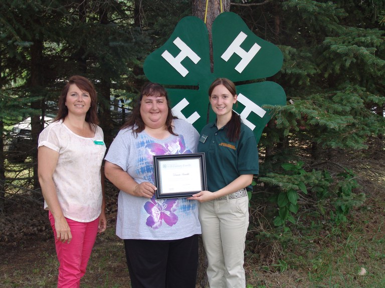 Dorinda Rutschke (center) and Casondra Rutschke (right) receive recognition from Leann Schafer, North Dakota 4-H Foundation Board chair. The Rutschkes are members of the James and LuElla Klein family, which was named a 4-H century family.