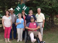 Marion Linnell (center) receives recognition on behalf of her late husband, Ole, who was inducted into the North Dakota 4-H Hall of Fame. The others are (from left) Leann Schafer, North Dakota 4-H Foundation Board chair; Delvin Dukart, Dunn County 4-H leader and 4-H Council member; Kelley Dukart, Dunn County 4-H leader and 4-H Council member; daughter Karen Linnell; Duane Hauck, former NDSU Extension Serivce director; and grandson Kris Linnell (seated).
