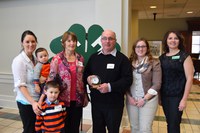North Dakota 4-H Hall of Fame inductee Larry Leier is surrounded by his family and Leann Schafer, North Dakota 4-H Foundation Board chair (far right). Family members are (from left) daughter Nicole VanderVorst, grandsons Judson and Dawson VanderVorst, wife Rosalind and daughter Marissa Leier.