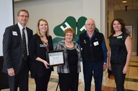 Viola and Chris Leier (center) receive recognition on behalf of their family, which was named a 4-H century family. Those presenting the recognition are (from left) Chris Boerboom, NDSU Extension Service director; Acacia Stuckle, an Extension agent for Emmons County; and Leann Schafer, North Dakota 4-H Foundation Board chair.