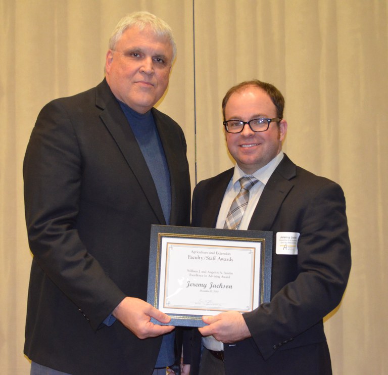 David Buchanan, associate dean for academic programs in the College of Agriculture, Food Systems, and Natural Resources (left), presents Jeremy Jackson, assistant professor, Department of Agribusiness and Applied Economics, with the William J. and Angelyn A. Austin Excellence in Advising Award.