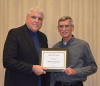 David Buchanan, associate dean for academic programs in the College of Agriculture, Food Systems, and Natural Resources (left), presented Robert Baumann, agricultural research technician, Department of Plant Sciences, with the Rick and Jody Burgum Staff Award.