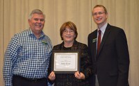 Linda Hauge, Extension 4-H youth development specialist, Center for 4-H Youth Development, receives the AGSCO Excellence in Extension Award from Chris Boerboom, director of the NDSU Extension Service (right), and Brad Cogdill, director of the Center for 4-H Youth Development.